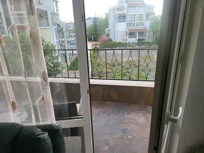 a sliding glass door with a view of a balcony at Luxury apartment opposite Kakao in Sunny Beach