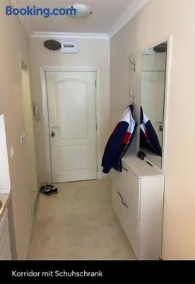 a room with a refrigerator with a mirror and a door at Marvel Deluxe in Sunny Beach