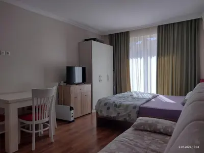 a bedroom with a bed and a desk and a table at Marvel Deluxe in Sunny Beach