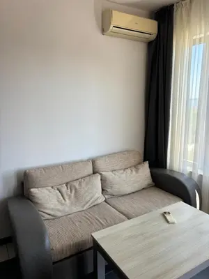 a living room with a couch and a table at Beachside apartment - 100 meters from the sea in Chernomorets