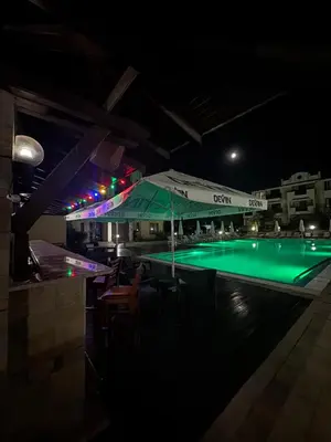 a swimming pool at night with a green illumination at Beachside apartment - 100 meters from the sea in Chernomorets