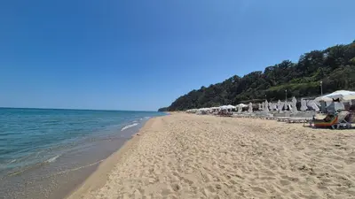 a beach with umbrellas and chairs and the ocean at Breathtaking sea view in Byala