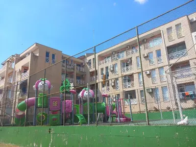 a playground in front of an apartment building at Слънчев бряг Sunny day 6 One bedroom apartment in Sunny Beach