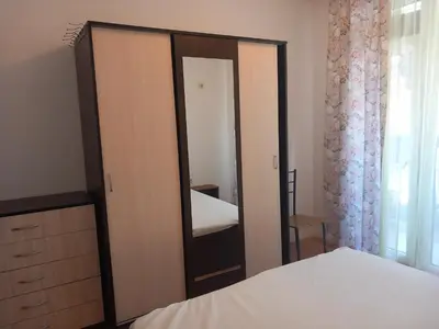 a bedroom with a mirror and a bed and a dresser at Слънчев бряг Sunny day 6 One bedroom apartment in Sunny Beach