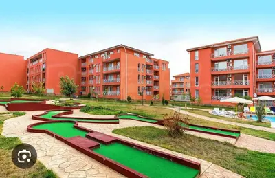 a group of buildings with green water in a courtyard at Слънчев бряг Sunny day 6 One bedroom apartment in Sunny Beach