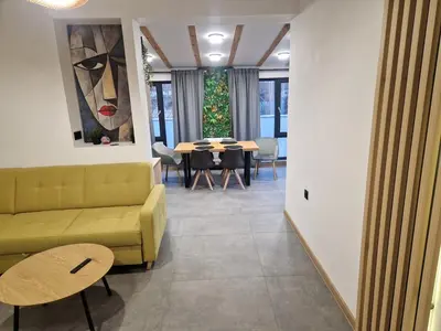 a living room with a couch and a table at Family House Burgas in Burgas City