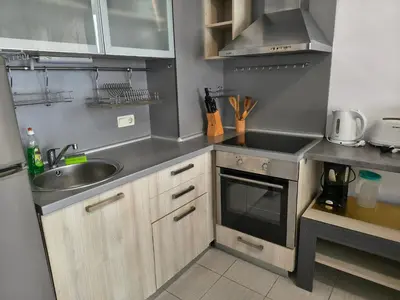 a small kitchen with a sink and a stove at Sunny sea apartment - 100 meters from the sea in Chernomorets