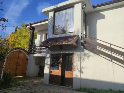 a house with a wooden door and a gate at При Приятели in Nesebar