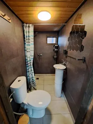 a bathroom with a toilet and a sink at Бунгало Борче in Burgas City