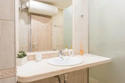 a bathroom with a sink and a mirror at Seaside Bliss in Varna City