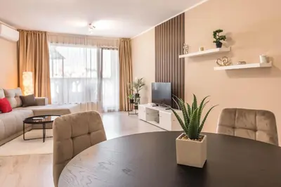 a living room with a table and chairs and a couch at Seaside Bliss in Varna City