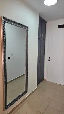 a large mirror in a room with two doors at Vladan apartments in Sozopol