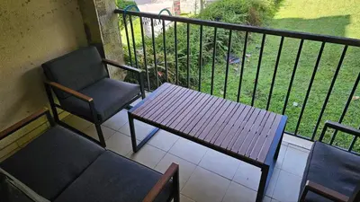 a balcony with a bench and a chair and a table at Vladan apartments in Sozopol
