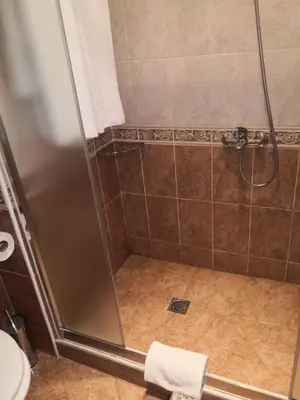 a shower with a glass door in a bathroom at Specious apartment near beautiful beach Pomorie in Pomorie