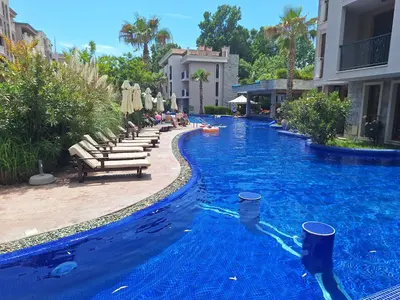 a swimming pool with blue water in a resort at 3 Room Apartment with Poolview in Cascadas Resort in Sunny Beach