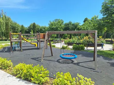a playground in a park with a swing at 3 Room Apartment with Poolview in Cascadas Resort in Sunny Beach