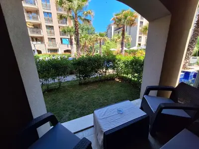 a view of a patio with chairs and a table at 3 Room Apartment with Poolview in Cascadas Resort in Sunny Beach