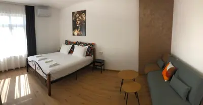 a small bedroom with a bed and a couch at Calendula in Burgas City