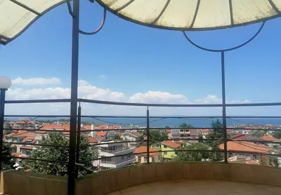 a view of a city from a balcony with an umbrella at Hotel Andre in Burgas City