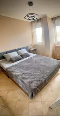 a large bed in a bedroom with a ceiling at AJ Apartment 3, Santa Marina Holiday Village, Sozopol in Sozopol