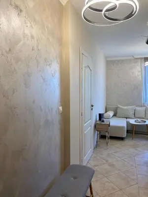 a living room with a couch and a wall at AJ Apartment 3, Santa Marina Holiday Village, Sozopol in Sozopol
