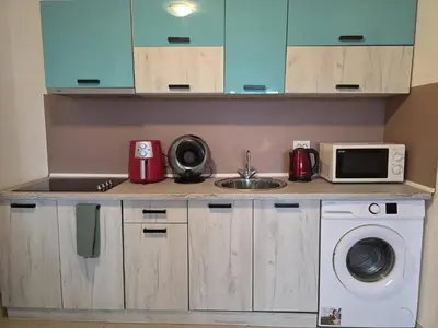 a kitchen with a sink and a microwave at Perla View Apartment in Primorsko