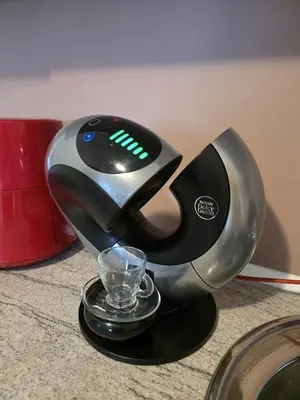 a juicer sitting on a counter with a glass in it at Perla View Apartment in Primorsko
