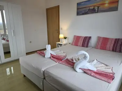 a bedroom with two swans towels on a bed at Perla View Apartment in Primorsko
