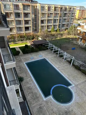 an empty swimming pool in front of a building at 