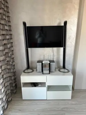 a white entertainment center with a flat screen tv on it at 