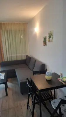 a living room with a couch and a table at Апартамент in Burgas City