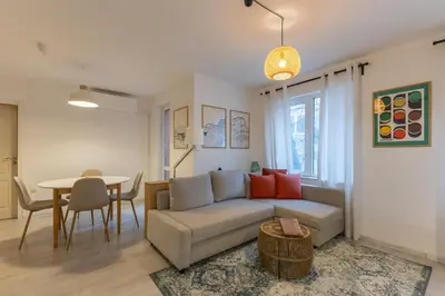 a living room with a couch and a table at Central 2BR - Workspace with Elevator in Varna City