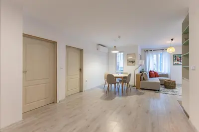 a living room and dining room with a table and chairs at Central 2BR - Workspace with Elevator in Varna City