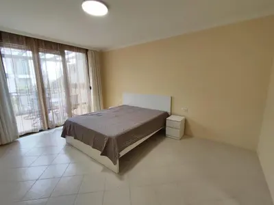 a bedroom with a bed and a large window at Santa Marina Breeze in Sozopol
