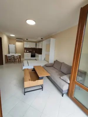 a living room with a couch and a table at Santa Marina Breeze in Sozopol