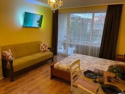 a living room with a couch and a table at Elegant Studio near Beach - Terrace & Parking in Nesebar