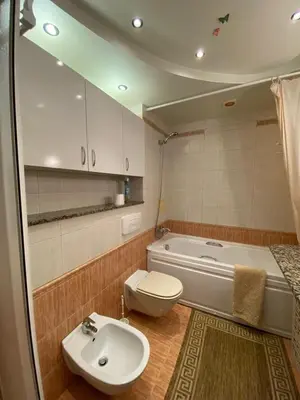 a bathroom with a toilet and a sink and a tub at Beautiful family appartment with sea view in Byala
