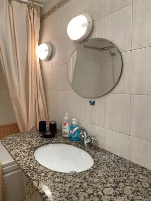 a bathroom counter with a sink and a mirror at Beautiful family appartment with sea view in Byala