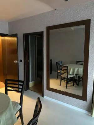 a mirror in a room with a table and chairs at Beautiful family appartment with sea view in Byala
