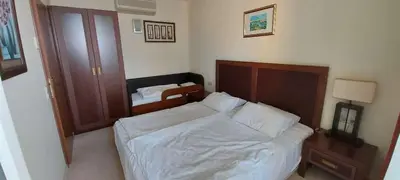 a bedroom with a bed with white sheets and a mirror at Sunset C8-10 Pomorie in Pomorie