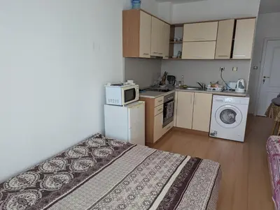 a small room with a bed and a kitchen at Sunny Day 5 in Tŭnkovo