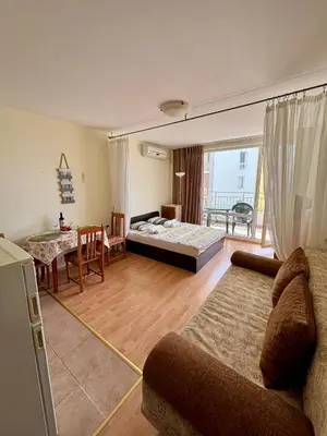 a living room with a couch and a table at Imperial Fort Club Studio Apartment in Sveti Vlas