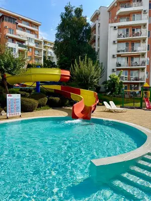 a water slide in a swimming pool in a apartment at Imperial Fort Club Studio Apartment in Sveti Vlas