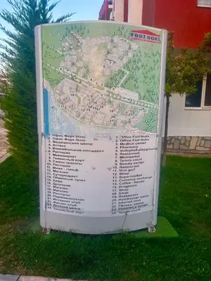 a large sign in the grass next to a building at Imperial Fort Club Studio Apartment in Sveti Vlas