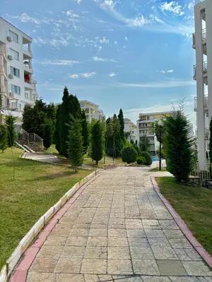 a cobblestone street in a city with buildings at Imperial Fort Club Studio Apartment in Sveti Vlas