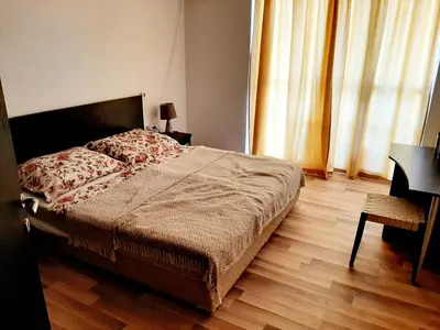 a bedroom with a bed and a wooden floor at Atlantis 8016 in Burgas City