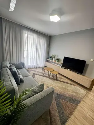 a living room with a couch and a flat screen tv at 1BD Apartment next to the Sea Garden by Flat Mаnager in Burgas City