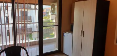 a room with a large window and a kitchen at Морската Къща in Tsarevo