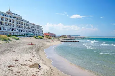 a view of a beach with a hotel and the ocean at Gardenia Beach Palace Aparthotel in Pomorie