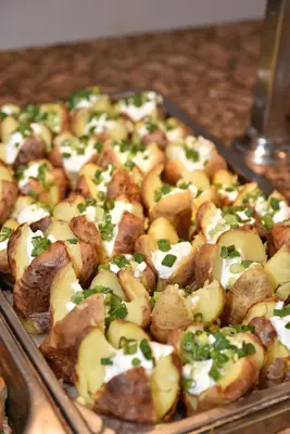 a tray of food with potatoes and green onions at Villas Ropotamo Maisonette in Primorsko